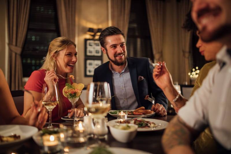 a group of people sitting at a dinner table